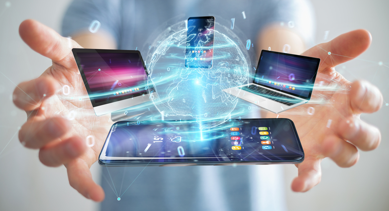 Modern devices connected to each other in businessman hand 3D rendering